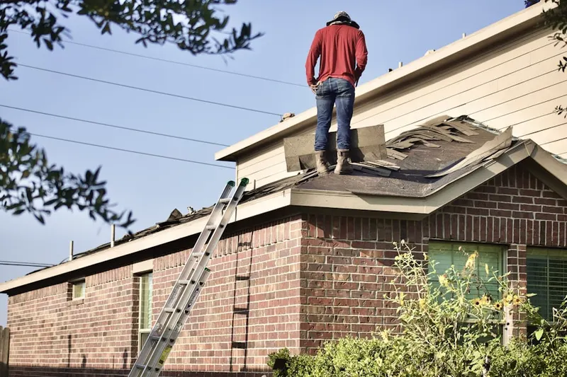 Professional roofer working on a residential roof in Edinboro